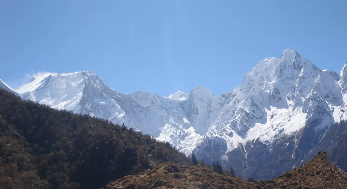 Trekker walking on the high-altitude trail of the Manaslu Circuit surrounded by snow-capped Himalayan peaks